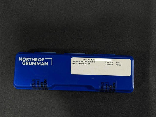 Blue Northrop Grumman component on a black background